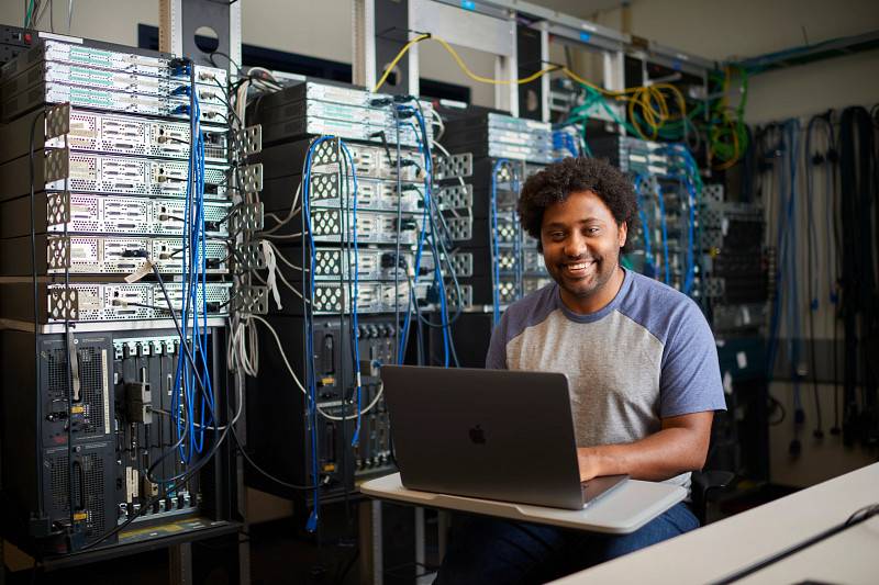 A GVSU computer science student in a technology lab.